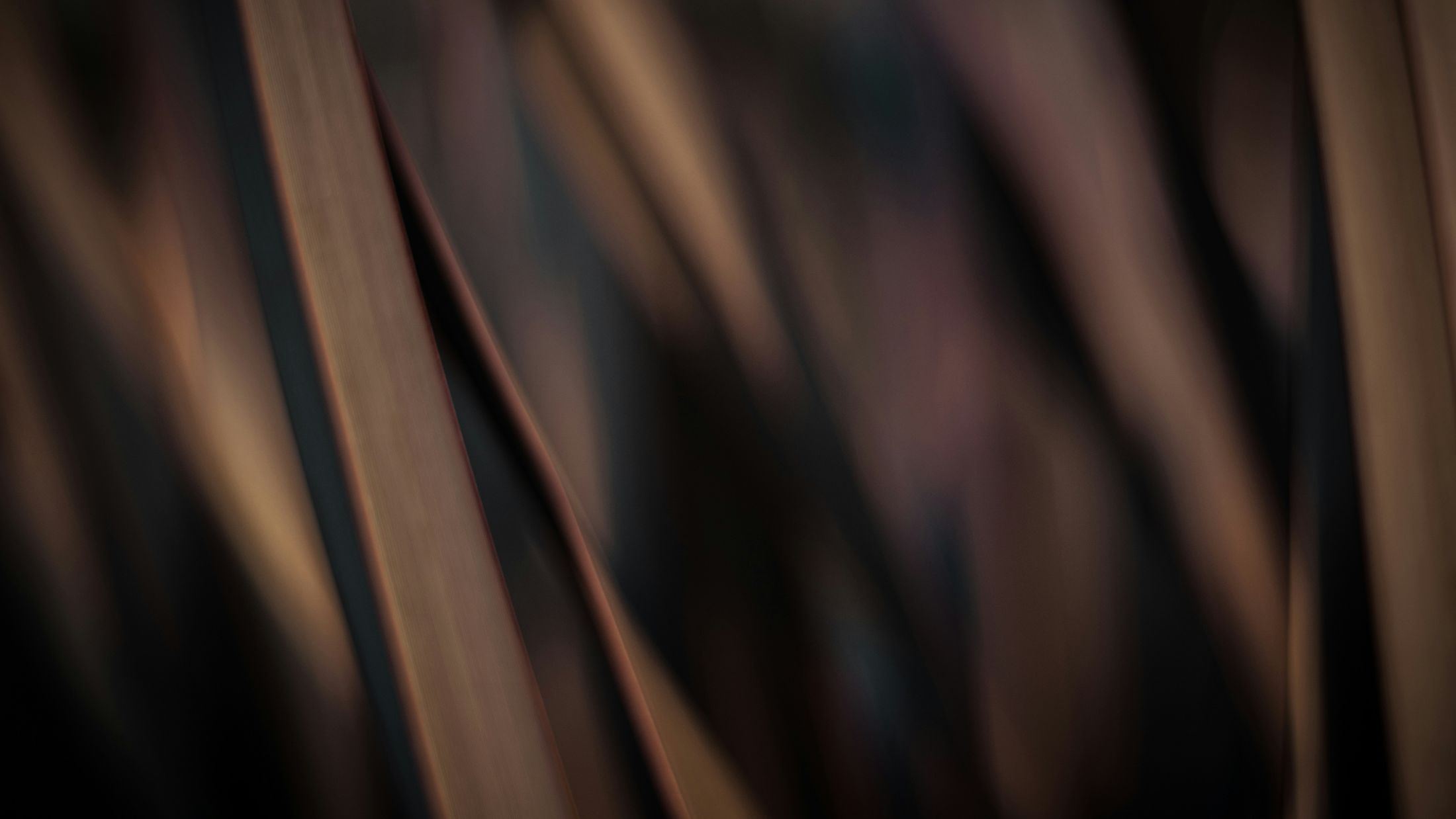 Abstract brown and black blurred background texture.