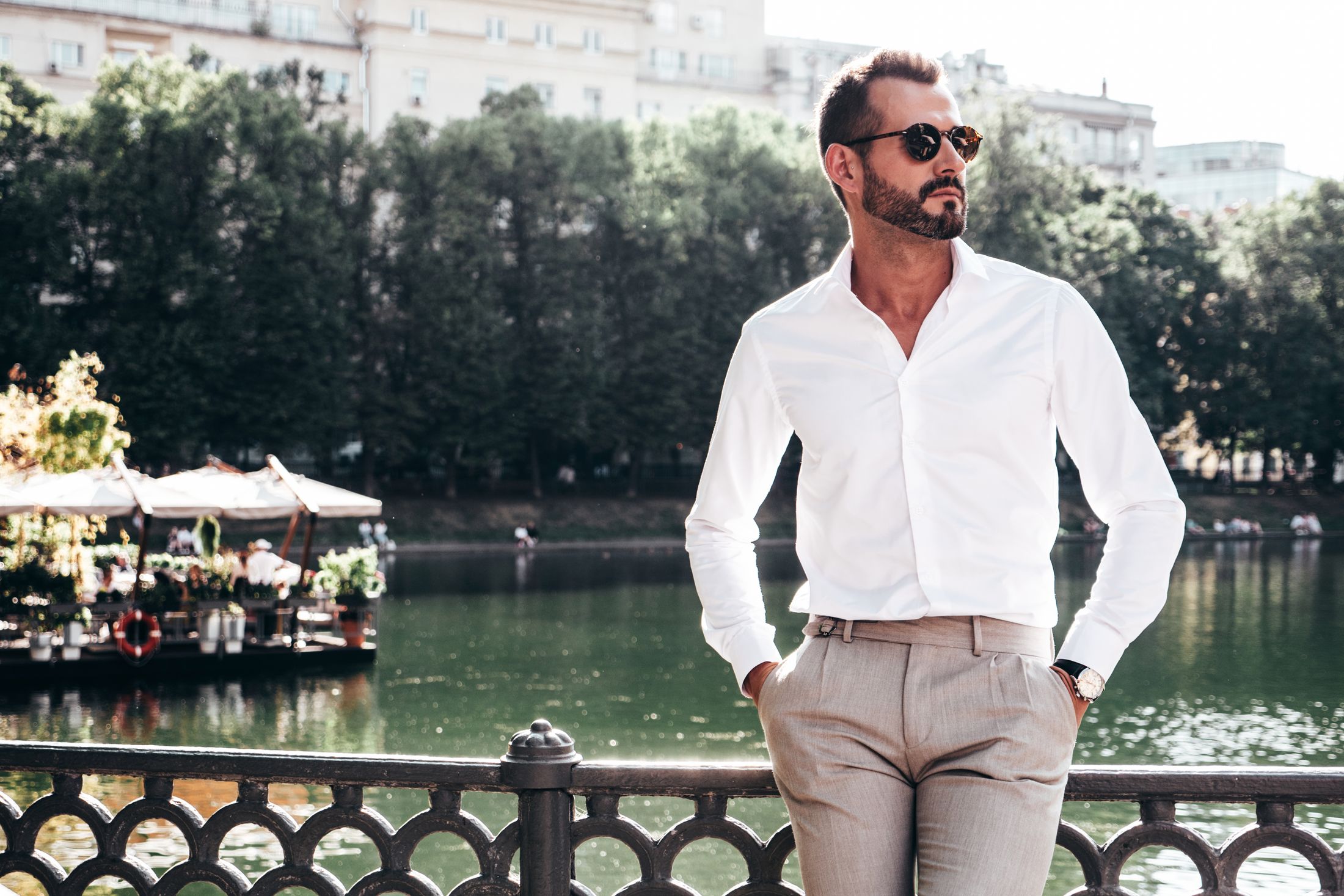 male med spa patient model in a white dress shirt and slacks by a body of water