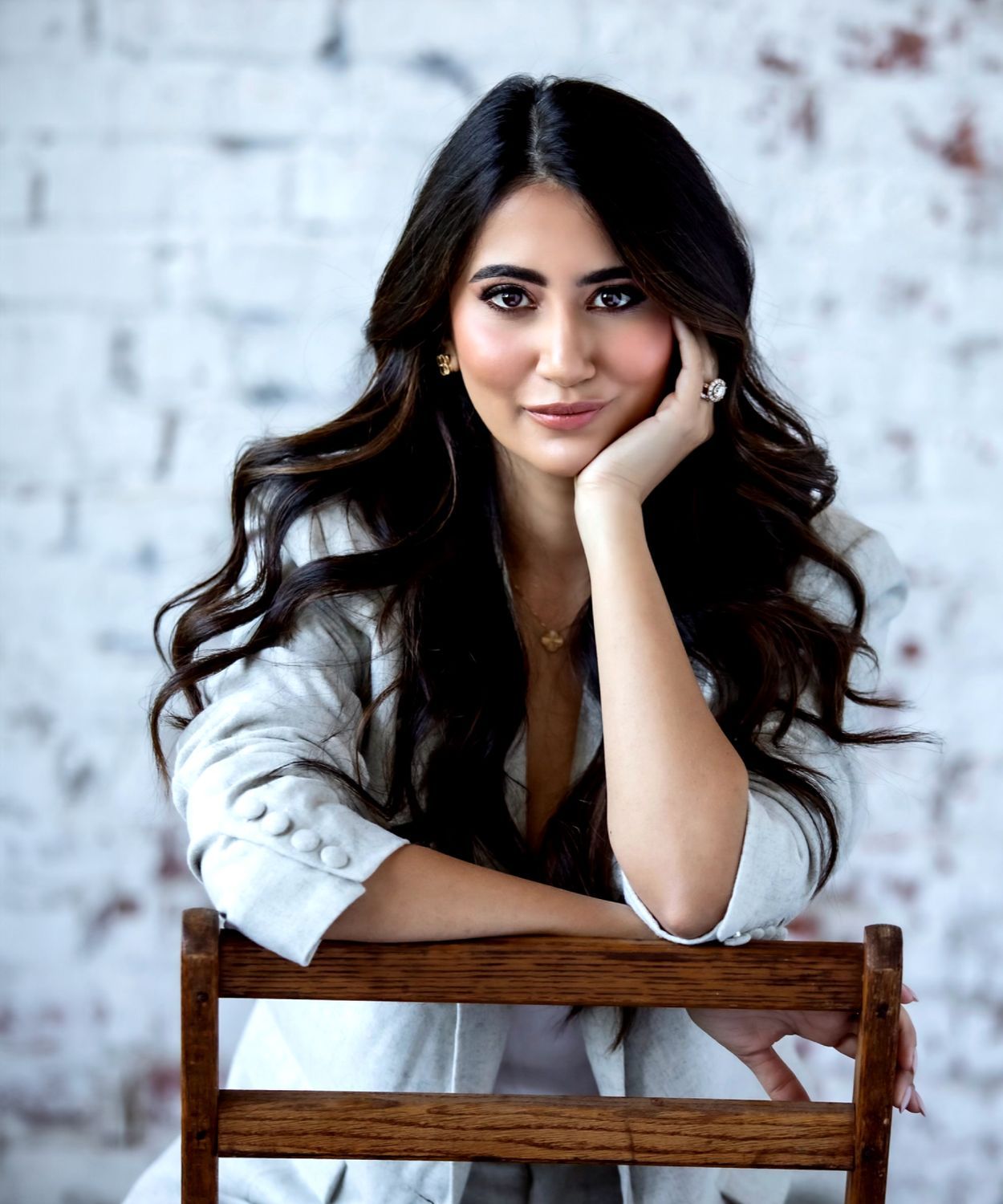 karishma lakhani sitting in a char and resting her head in her hand