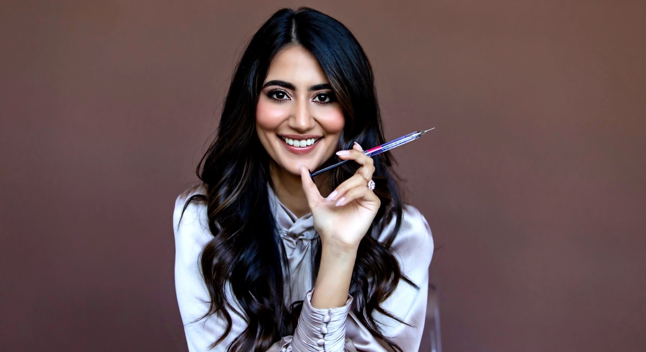 karishma lakhani holding a cannula and smiling