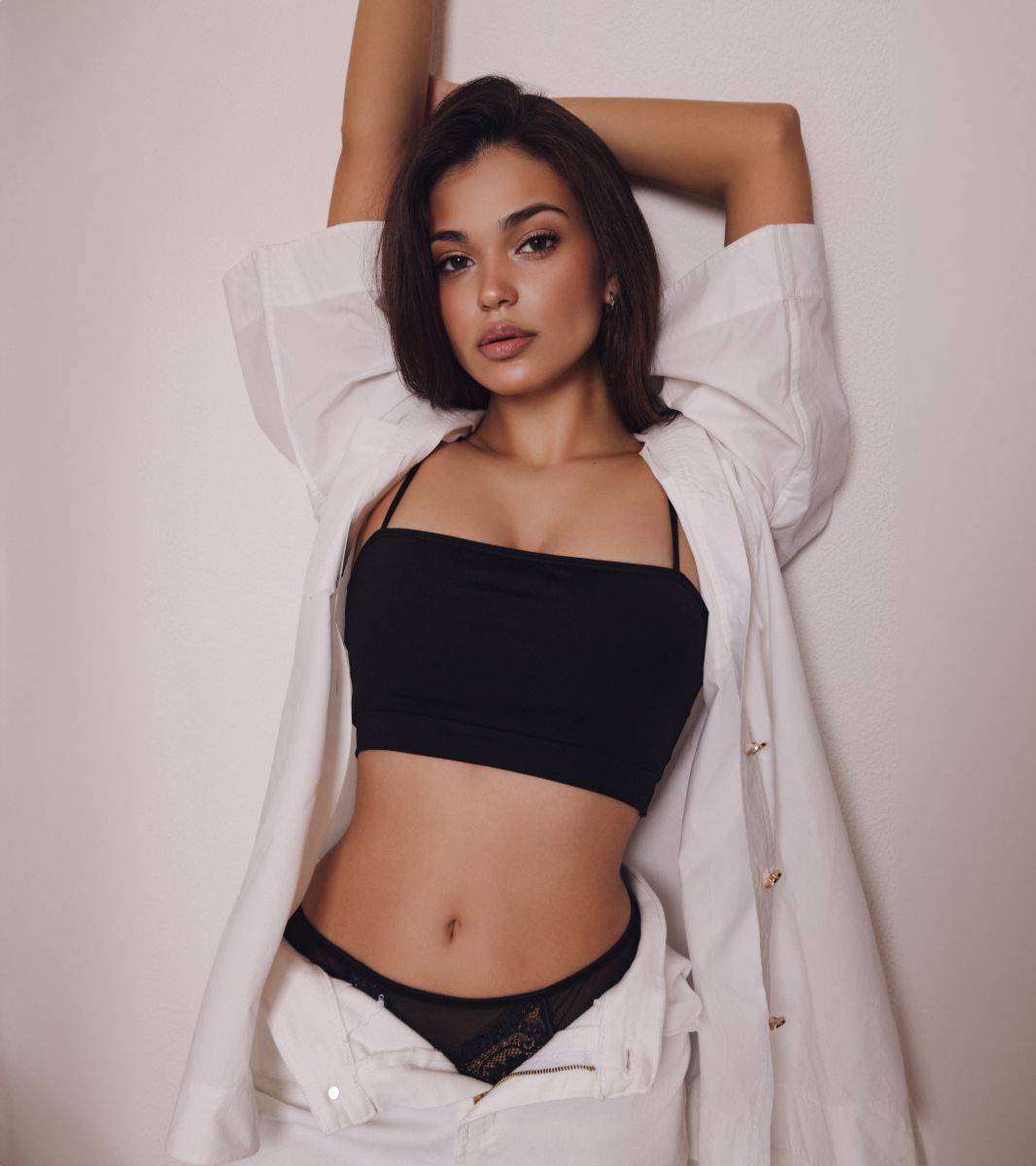 wellness patient model in a oversized white coat and black tank top