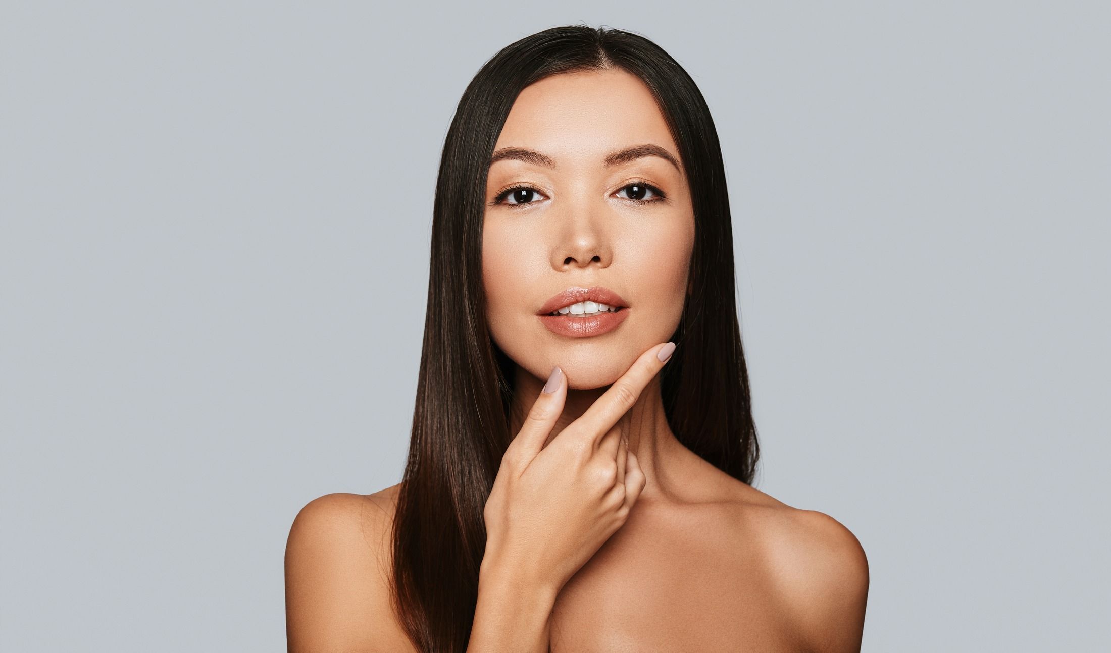 skincare patient model touching her chin